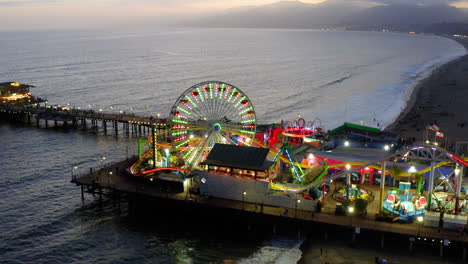 santa monica pier at dusk with illuminated rides