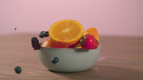 fruit falls into bowl on table