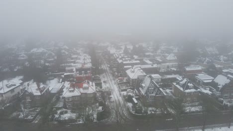 aerial of beautiful suburban neighborhood on a cold and misty winter day