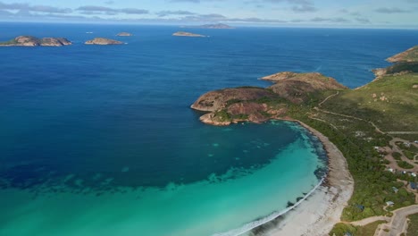 aerial view over a campground next to the beach, lucky bay, esperance - australia - orbit, drone shot