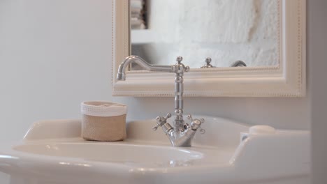 slow establishing shot of a minimal white wash basin in a villa bathroom