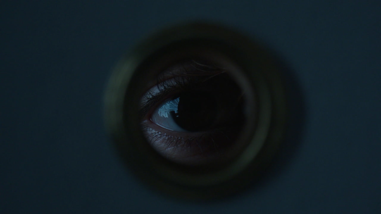 Eye Peeking Through a Door