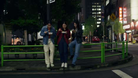 friends eating noodles in the night city