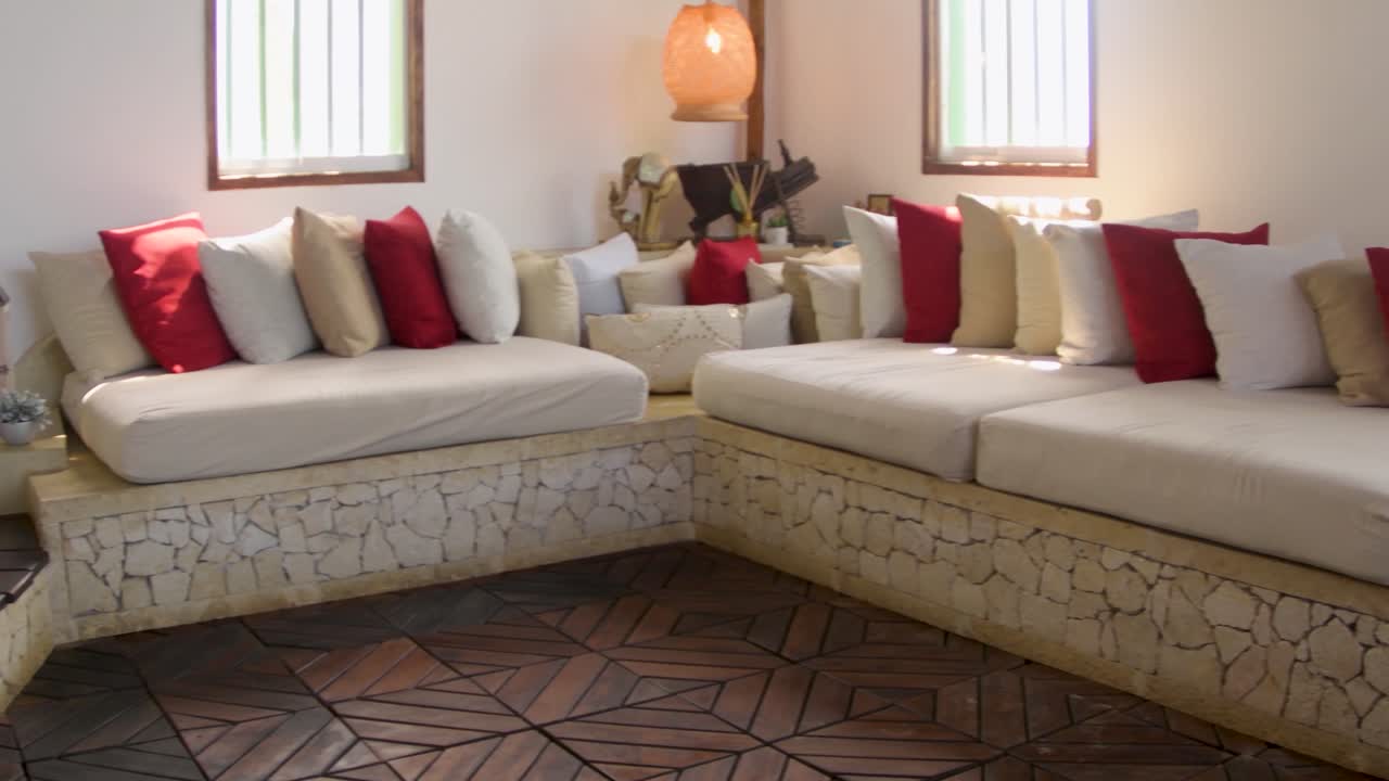 Warmth tropical living room interior decoration, pastel tones with red, pan right hotel