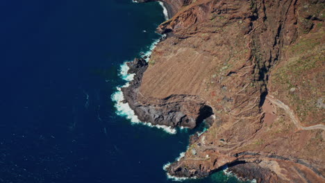 aerial drone shot over the poris de la candelaria cave in la palma island, canary islands, spain.
exclusive summer holidays private properties located inside a cave along the rugged coastline.