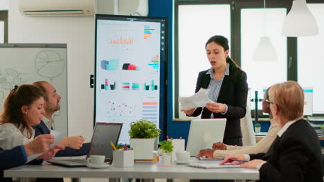 angry business woman screaming at diverse colleagues during office meeting