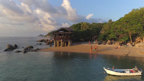 tropical beach sunset with people relaxing