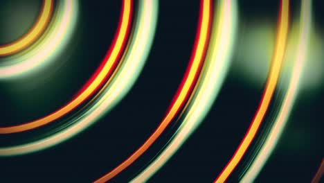 abstract looping video background of circular shapes in shiny orange and green