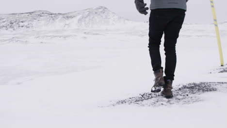 Young-Male-Traveler-Walking-through-blizzard-in-slow-motion