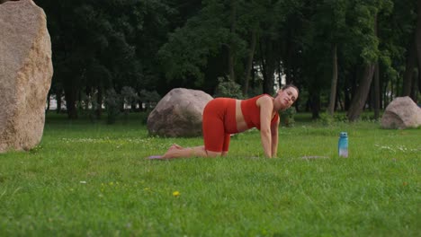 pregnant woman practicing yoga in a park