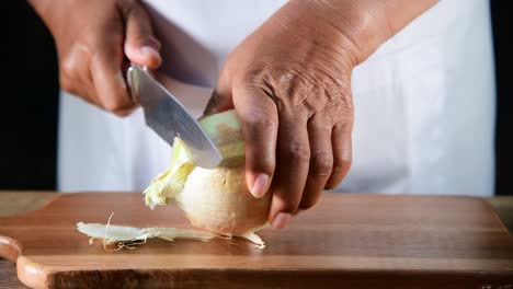 a woman hands peel fresh onion