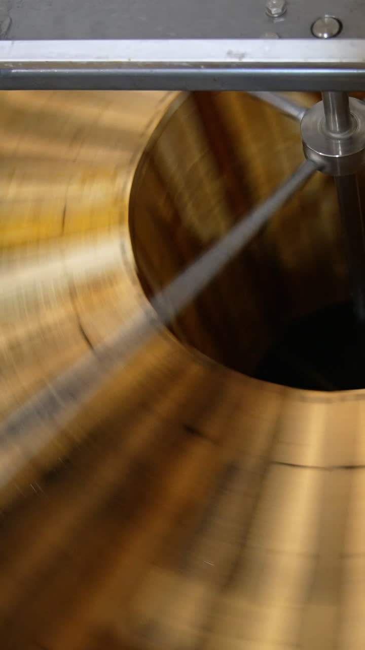 Quick spinning of honey frames in the automatic machine. Wooden honey frames are rotated to remove fresh organic honey from them. Vertical video
