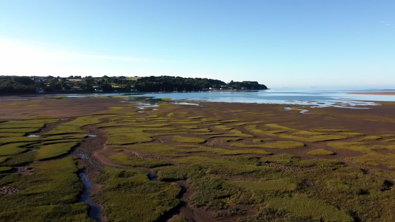 Aerial view Traeth Coch scenic patterned salt marsh moorland rural countryside at sunset