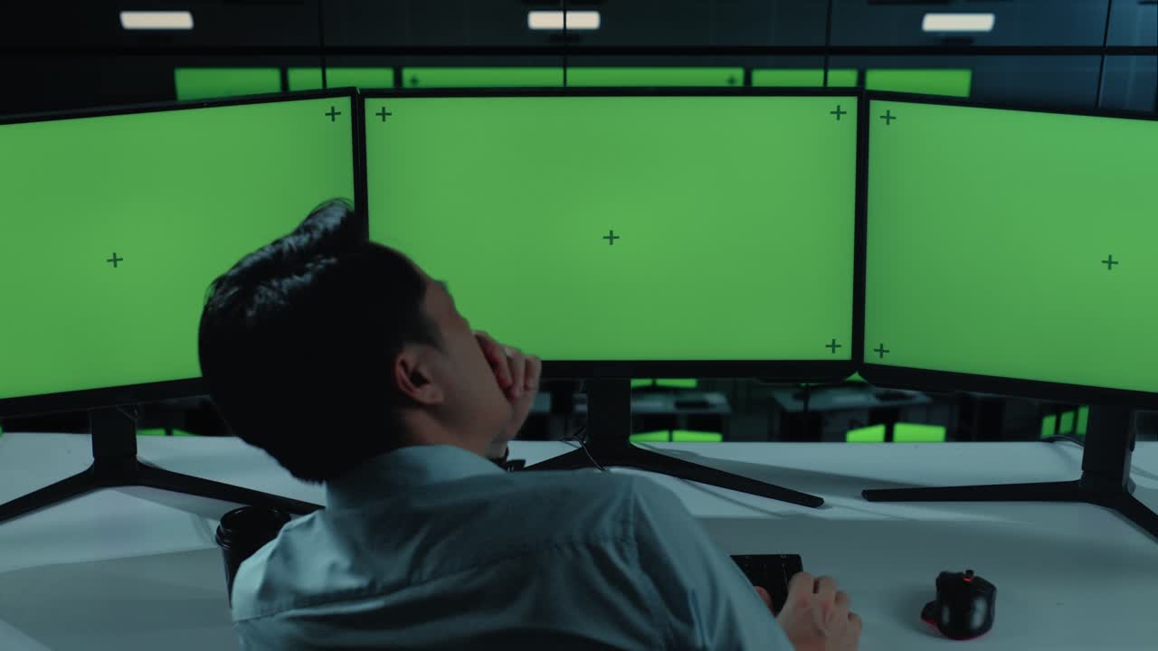 Back View Of Tired Asian Man Yawning Before Sleeping While Working With Mock Up Multiple Computer Monitor In The Office