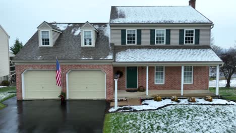 american house in neighborhood with usa flag