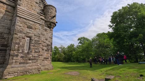 visitors gather outside historic monument in scotland