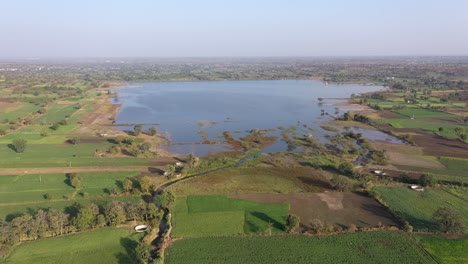 Stausee-Umgeben-Von-Grünen-Feldern-An-Einem-Sonnigen-Tag