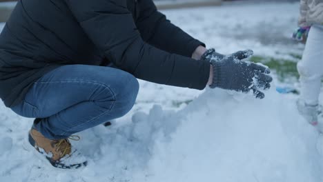 grandfather and granddaughter having fun in the snow