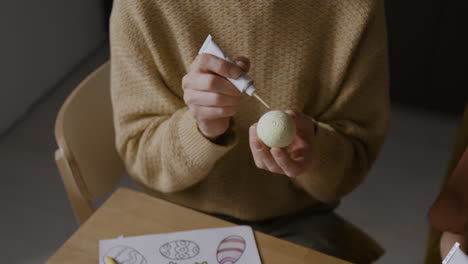 woman decorating easter eggs