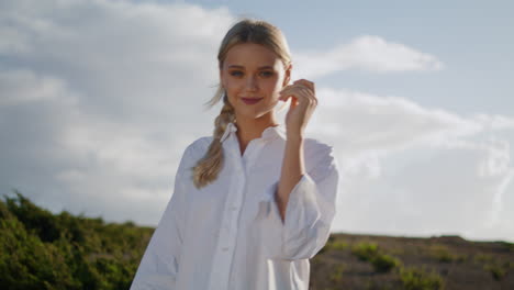 Beaming-lady-walking-hilltop-alone-closeup.-Smiling-girl-stepping-valley-nature