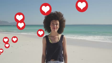 multiple heart icons floating against portrait of african american woman smiling on the beach
