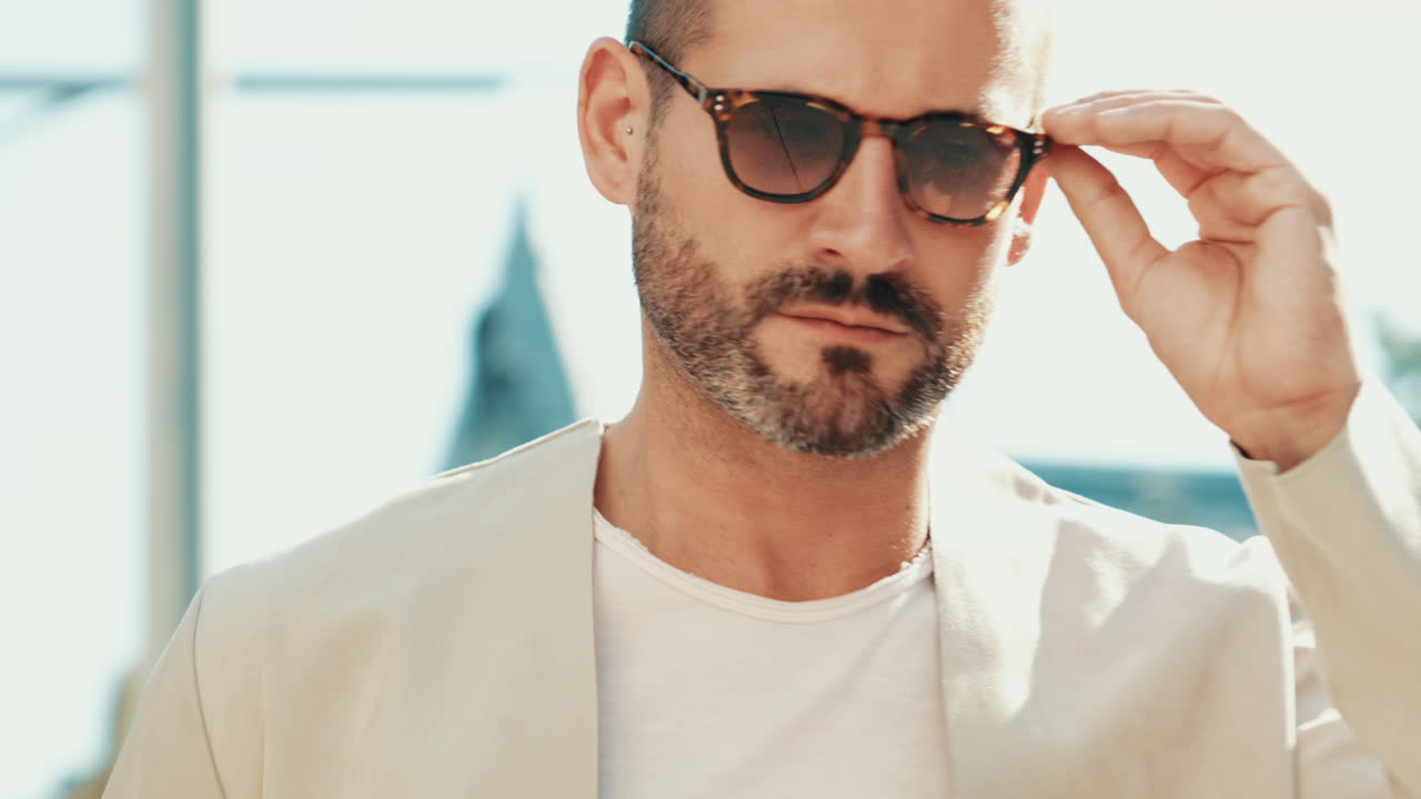 베이지 블레이저와 선글라스를 입은 남자