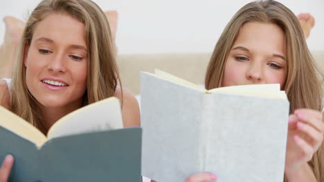 Smiling women reading interesting novels