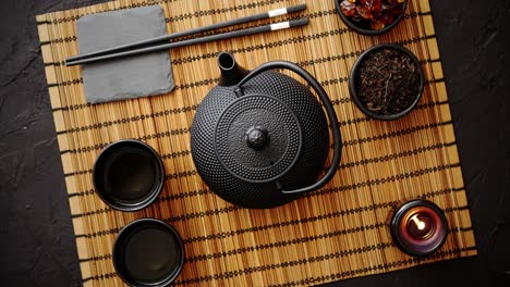 asian green tea set on bamboo mat