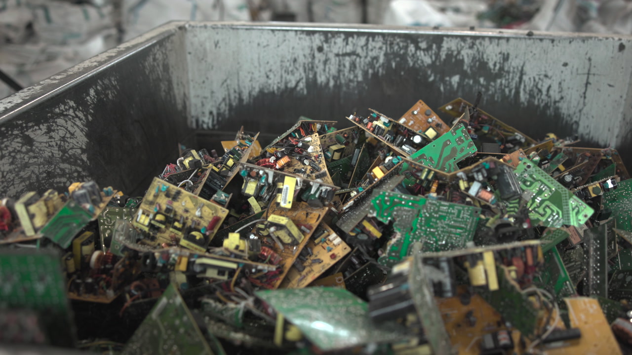 Industrial Bin Loaded With Mixed Circuit Boards And Modules, Varied Green And Brown PCBs With Coils . Media