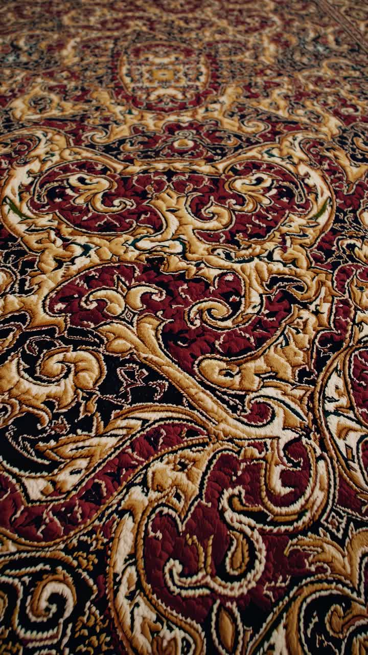 Close-up view of an elaborate carpet design, highlighting the skilled craftsmanship and rich color palette with intricate patterns and textures creating a luxurious and decorative floor covering