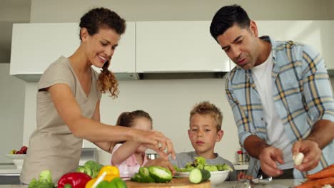 parents preparing a salad with their children