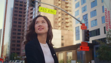 happy woman going on crosswalk close up. asian businesswoman crossing road.