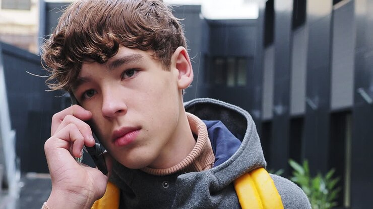 Teenage boy talking on the phone