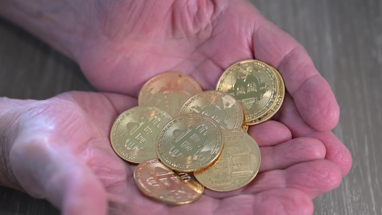 Bitcoin coins held in hands