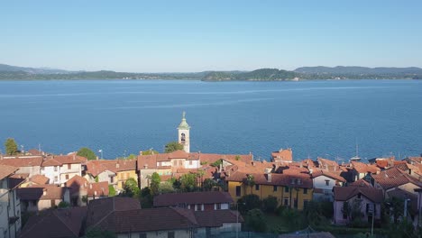 Aerial-pan-left-panoramic-view-of-Belgirate-village-on-Lake-Maggiore,-Italy