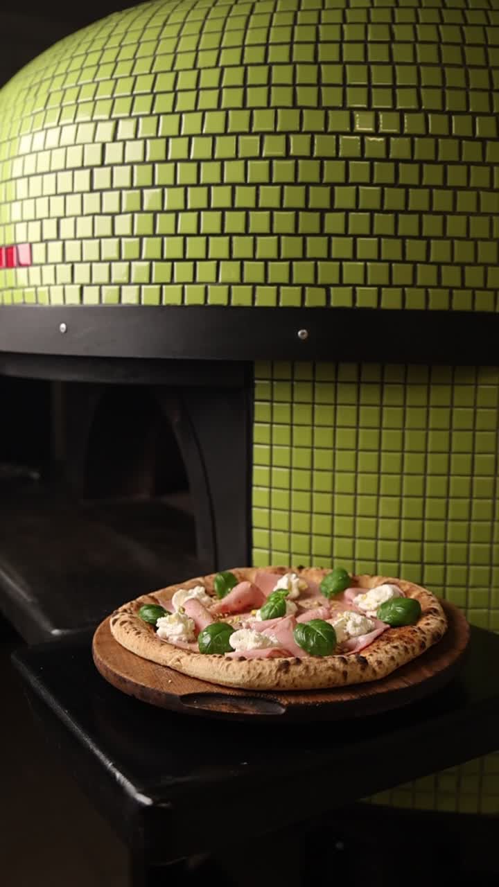 Pizza Gourmet con prosciutto e basilico davanti a un forno in muratura