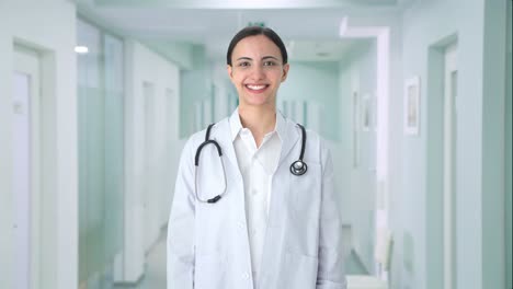 happy indian female doctor putting stethoscope on shoulders