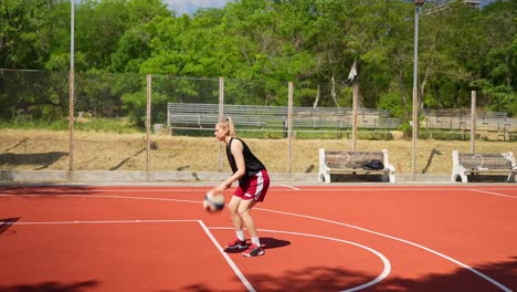 woman playing basketball outdoors