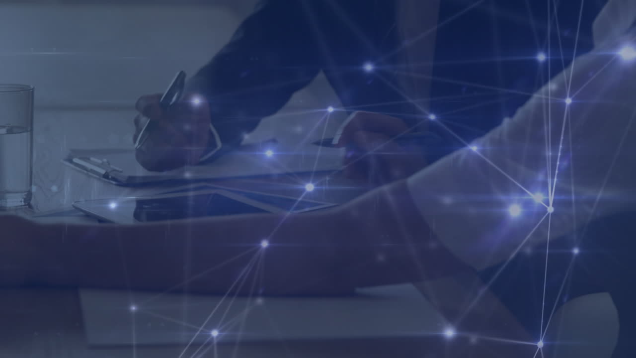 Animation of network of connections over hands of caucasian businesspeople working