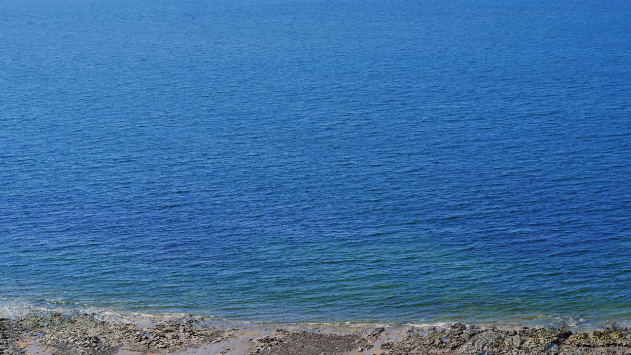 Beautiful Clear Blue Sea Water in Gower Peninsula on Sandy Rocky Beach. Holiday Tourism Nature Footage.