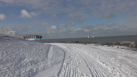 giant container vessel marstal maersk sailing at the maasgeul for entering the port of rotterdam on a cold partly cloudy winter day. wide timelapse