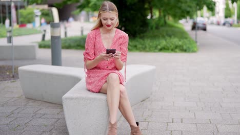 woman using smartphone on a bench