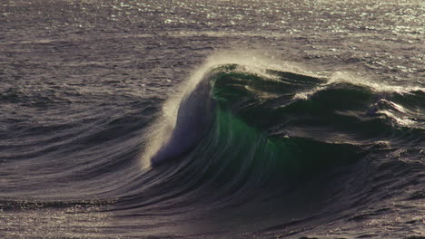 textured surface shimmers as wave recedes under calm evening sky, soft tide reflections