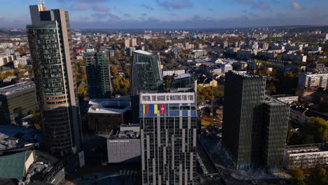 vilnius modern business skyscapers aerial with putin anti war banner