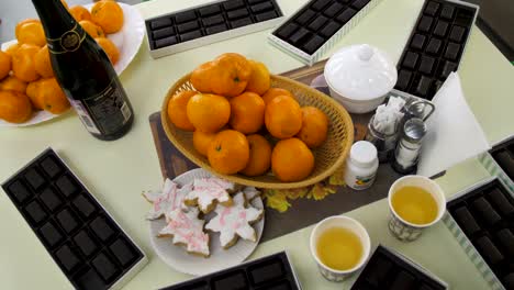 holiday dessert table with chocolate, oranges, and cookies