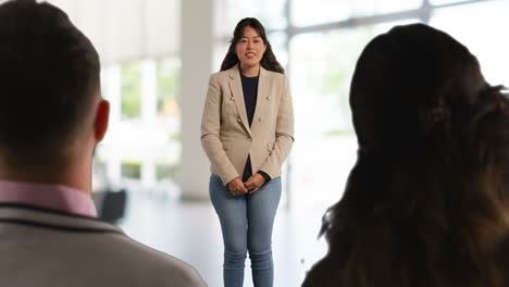 Businesswoman-Or-Female-College-Teacher-Giving-Presentation-Or-Lesson-In-Office-Or-Classroom