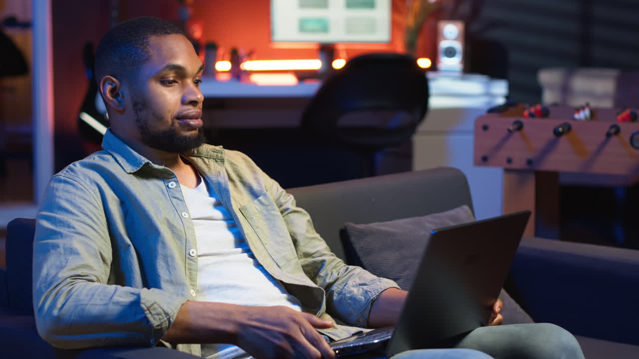 Vertical Video African american freelancer listening to podcast being focused on online work