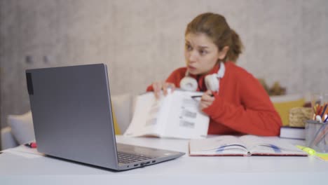 Girl-in-headphones-learns-online-on-computer,-communicates-with-teacher,-writes.