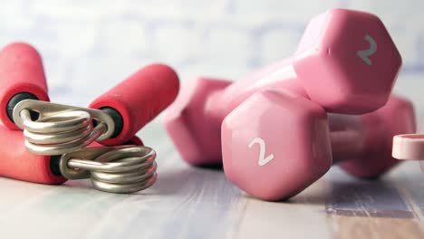 pink dumbbells and hand grips