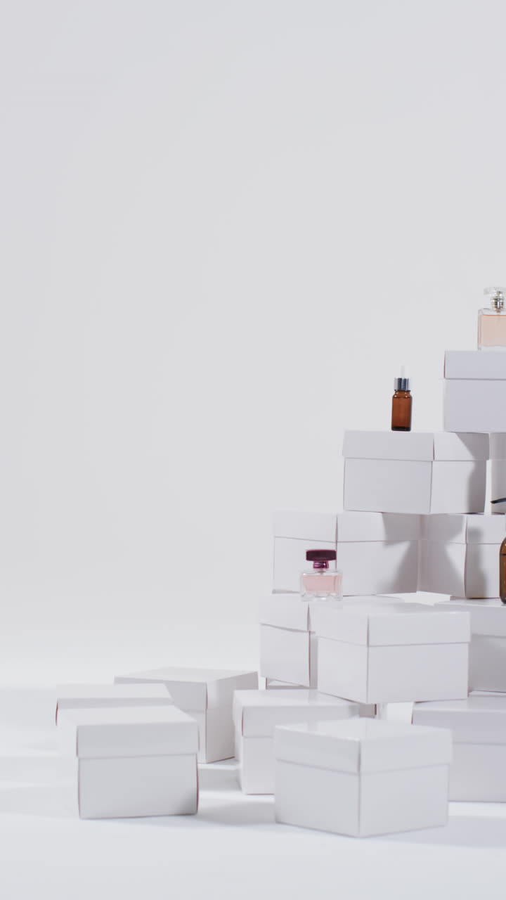 Vertical video of beauty products with white cardboard boxes with copy space over white background